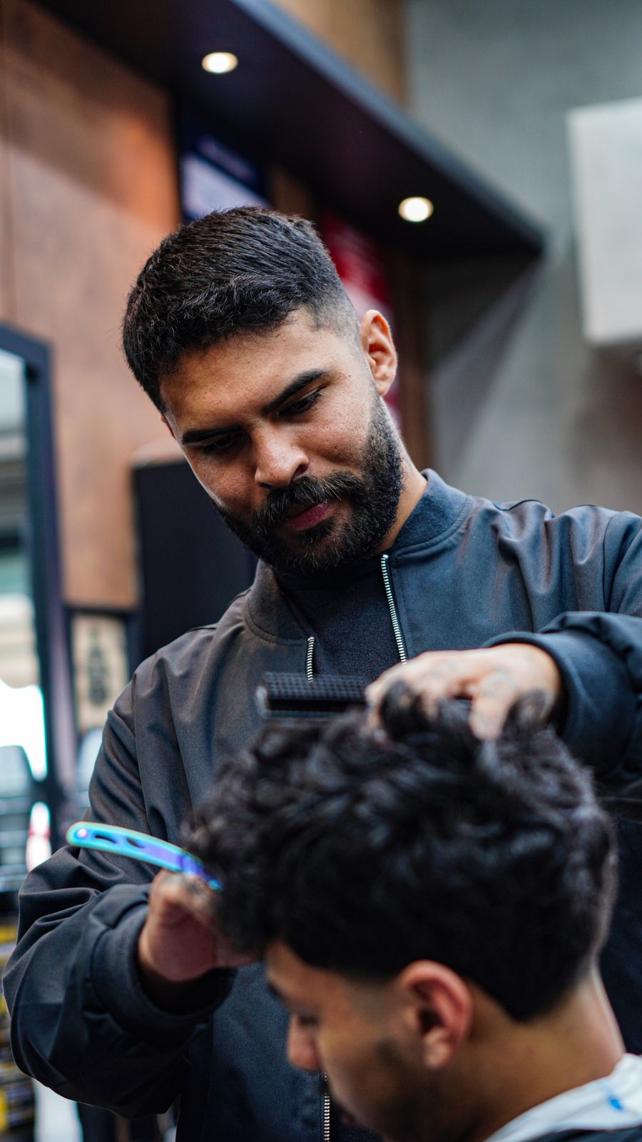 Barbeiro da Hebreus finalizando corte de cabelo masculino